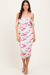 woman wearing a strapless floral midi dress with ruching and off-the-shoulder ties