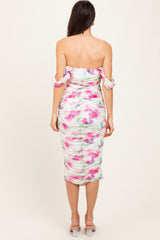woman wearing a floral print off-shoulder bodycon dress with ruched detailing and short sleeves