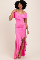 woman wearing a hot pink off-shoulder dress with ruffle details and a high slit