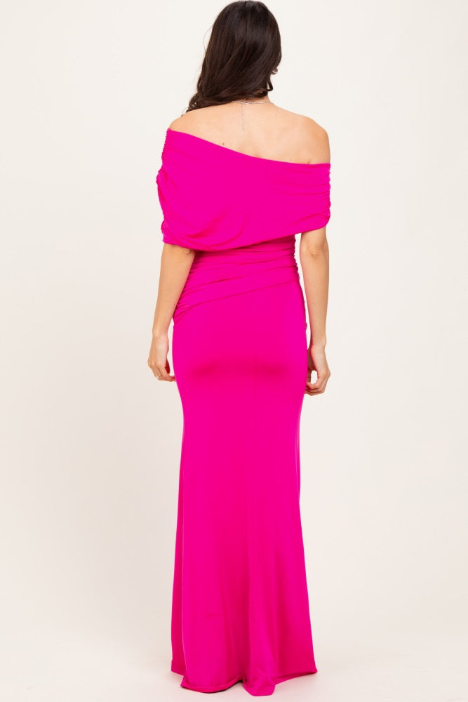 woman wearing a bright pink off-the-shoulder maxi dress with a fitted silhouette and draped neckline seen from the back