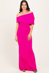 woman wearing a bright pink off-the-shoulder maxi dress with ruched details