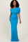 woman wearing a vibrant turquoise off-shoulder evening gown with ruched detailing and a fitted silhouette
