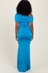 woman wearing a fitted off-the-shoulder bright blue maxi dress from the back