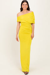 woman wearing a yellow off-the-shoulder fitted dress with ruched details and a long silhouette