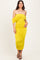 woman wearing a yellow off-shoulder ruched midi dress with a form-fitting silhouette and strappy black heels