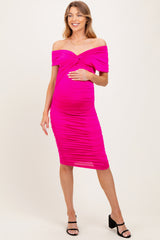 woman wearing a hot pink off-the-shoulder maternity dress with ruching and a visible baby bump