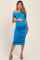 woman wearing a bright blue off-the-shoulder maternity dress with ruching and displaying her baby bump