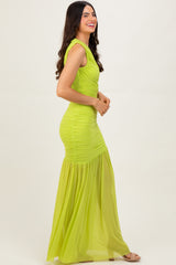 woman wearing a fitted neon green maxi dress with ruched detailing and a flared bottom