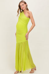 woman wearing a bright lime green one-shoulder maternity gown with ruching and a flowing skirt, showcasing her baby bump