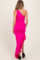 woman wearing a hot pink one-shoulder maternity dress with a ruffled hem