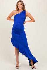 woman wearing a royal blue one-shoulder maternity dress with ruffle detailing and a visible baby bump