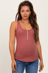 woman wearing a dusty rose maternity tank top with buttons, showing her baby bump, paired with blue jeans