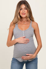 woman wearing a gray ribbed maternity tank top and holding her baby bump