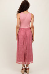 woman wearing a pink maxi dress with a lace skirt and a fitted top, showing the back view