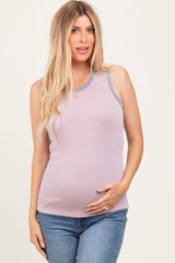 woman wearing a lilac ribbed maternity tank top and holding her baby bump