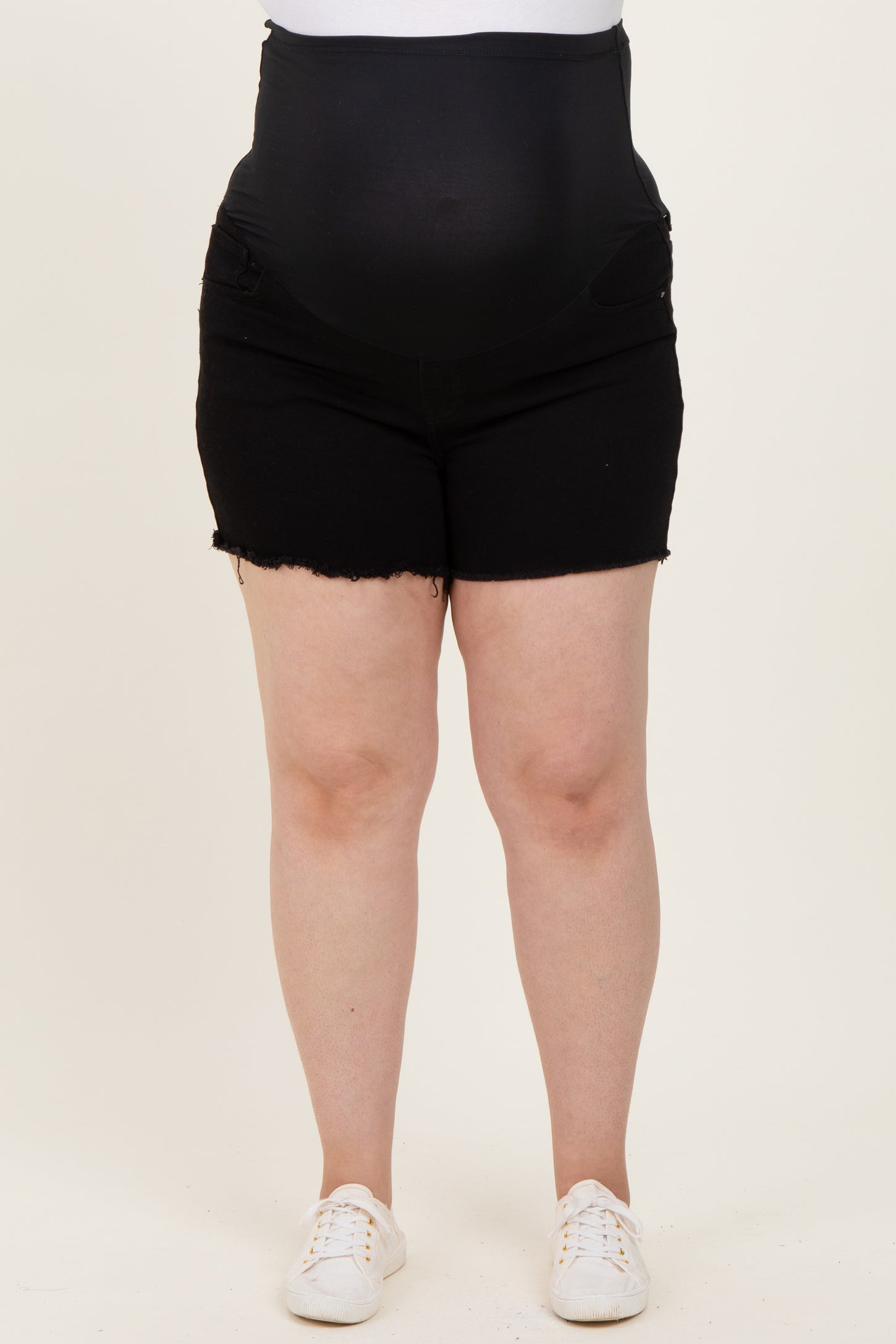 maternity plus black denim shorts with a supportive belly band and frayed hem, model showing baby bump