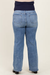 woman wearing a blue denim maternity plus jeans with a supportive waist panel, viewed from the back