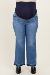 plus size woman wearing dark blue maternity jeans with a high waistband and a flared leg style
