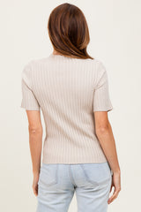 woman wearing a light beige ribbed short sleeve top, shown from the back with light blue high-waisted jeans