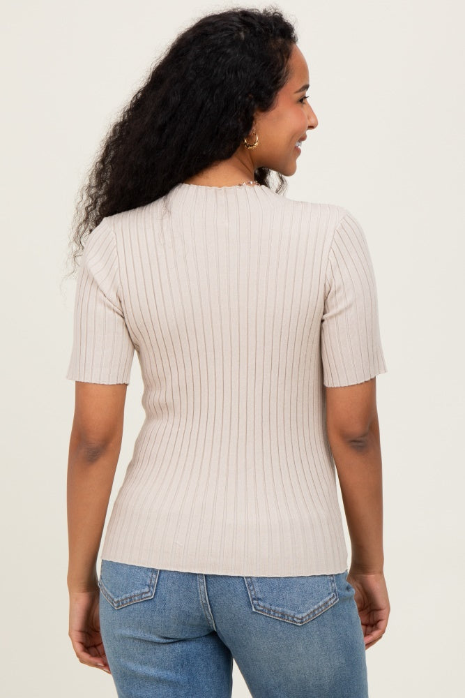 woman wearing a beige ribbed short sleeve maternity top, showing the back view