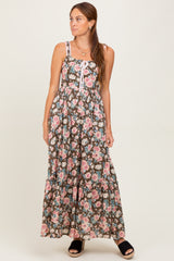 woman wearing a brown floral maxi dress with spaghetti straps and a tiered skirt