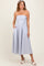 woman wearing a strapless blue and white striped midi dress with pockets and a fitted bodice