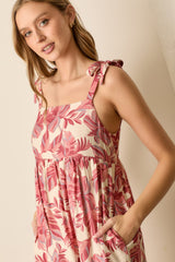 woman wearing a floral print sundress with tie straps and pockets