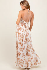 maternity wear white floral maxi dress with a halter neck and open back, model shown from behind