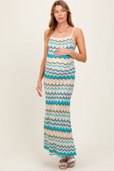 woman wearing a patterned maternity maxi dress with a chevron design and a visible baby bump
