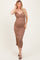 woman wearing a fitted brown ruched maternity dress with adjustable spaghetti straps and a baby bump visible