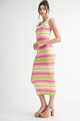 woman wearing a colorful striped ribbed midi dress with ruffled shoulder straps and tan platform sandals
