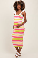 woman wearing a multicolored striped maternity dress with a fitted silhouette and holding her baby bump