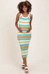 woman wearing a striped ribbed maternity dress in turquoise, orange, and white, holding her baby bump