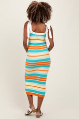 woman wearing a striped ribbed maternity dress with tie shoulder straps and a fitted silhouette, showcasing her baby bump
