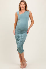 woman wearing a teal one-shoulder maternity dress that hugs her baby bump with ruched detailing