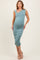 woman wearing a teal one-shoulder maternity dress that hugs her baby bump with ruched detailing