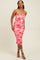 woman wearing a pink and orange floral print bodycon midi dress with adjustable spaghetti straps