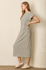 woman wearing a striped midi t-shirt dress with short sleeves and side pockets, styled with white sneakers