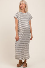 woman wearing a striped maternity maxi dress with short sleeves and a visible baby bump