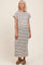 woman wearing a striped maternity maxi dress with short sleeves and a visible baby bump