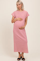 woman wearing a pink and white striped maternity maxi dress and holding her baby bump