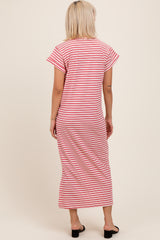 woman wearing a pink and white striped maternity maxi dress from the back
