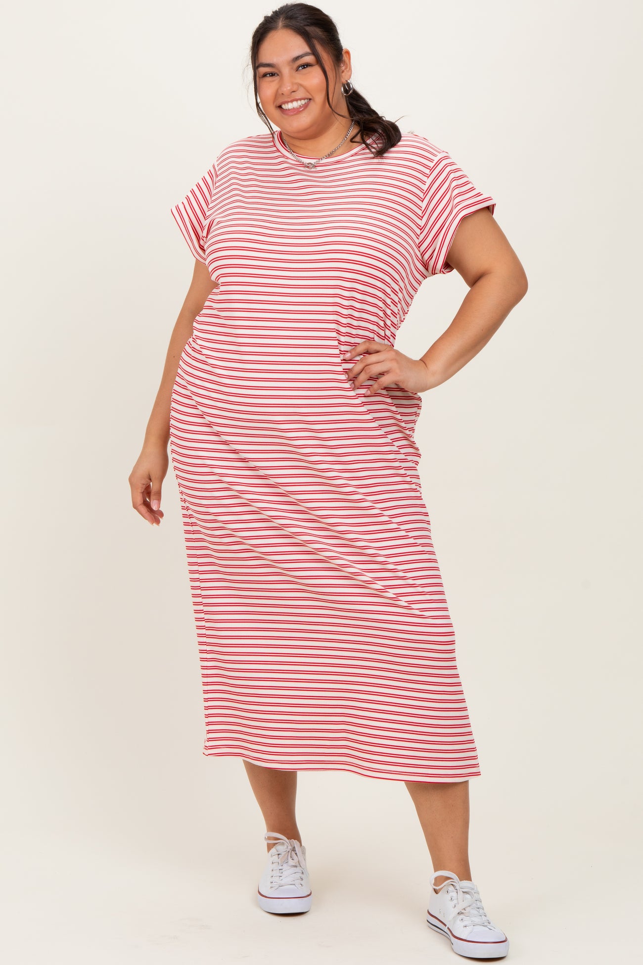 woman wearing a red and white striped plus size midi dress with short sleeves and a relaxed fit