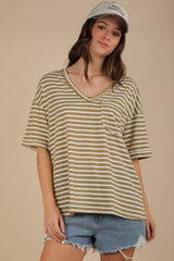 woman wearing an olive green and white striped oversized v-neck t-shirt with a front pocket and denim shorts