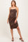 woman wearing a leopard print maternity dress with spaghetti straps and a visible baby bump