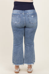 woman wearing light blue distressed maternity plus flared jeans with a navy waistband, showing her baby bump from the back