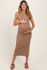 woman wearing a tan ribbed maternity dress and holding her baby bump