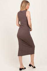 woman wearing a brown ribbed midi maternity dress, showing a fitted silhouette from the back