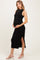 woman wearing a black ribbed maternity dress with side slits and holding her baby bump