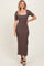 woman wearing a fitted ribbed midi dress in brown with short sleeves and a square neckline